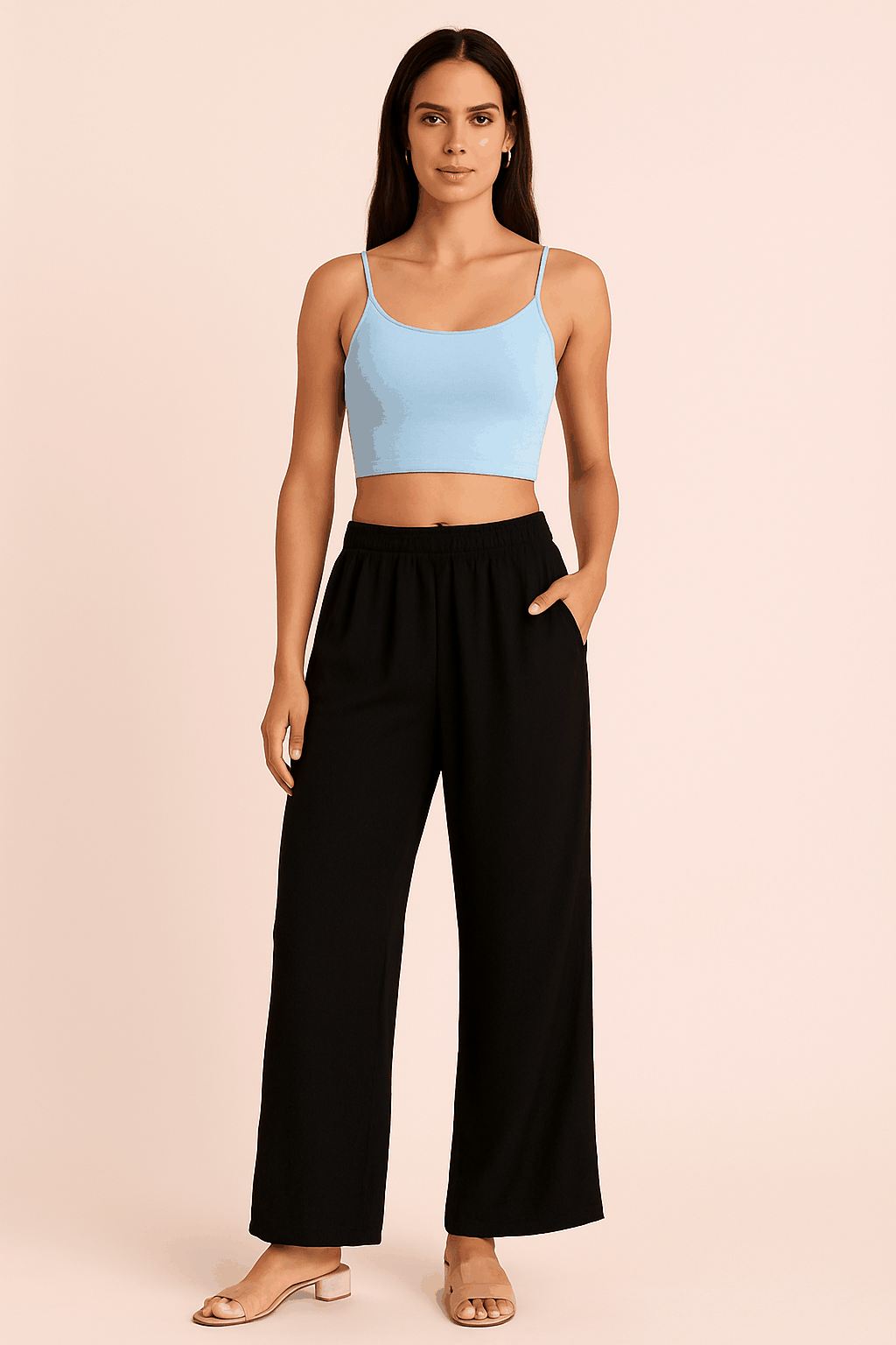 Woman wearing black ankle-length rayon plazzo pants with elastic waistband and loose fit.