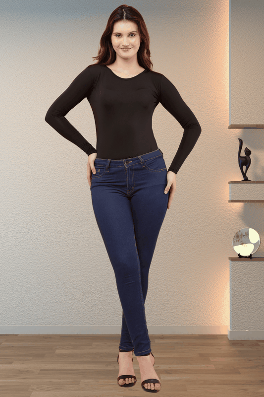 Woman wearing a black Women's Polylycra Round Neck T-shirt with long sleeves and slim fit paired with dark blue jeans and black heels.